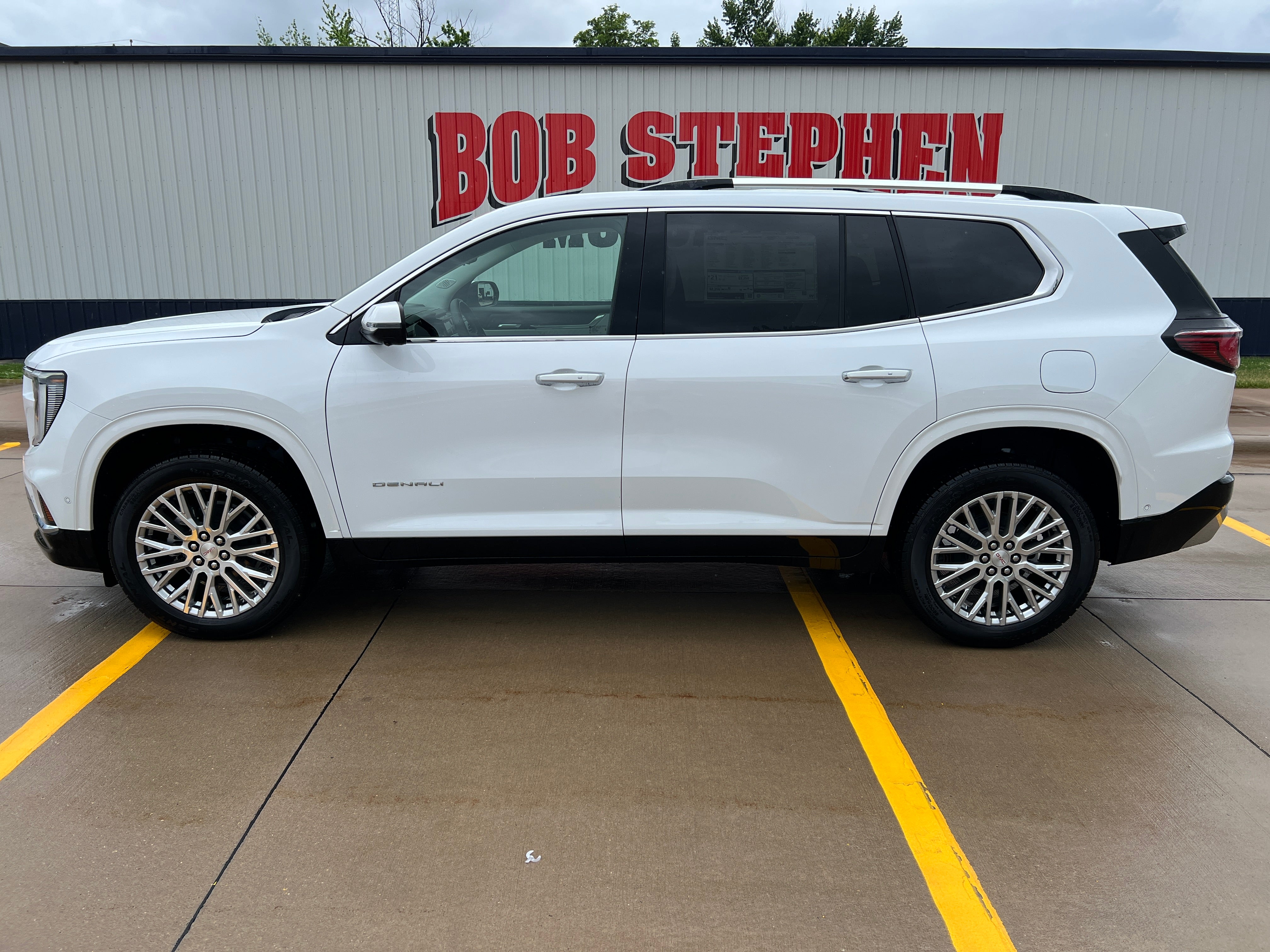 2026 GMC Acadia Denali in Summit White — front three-quarter view