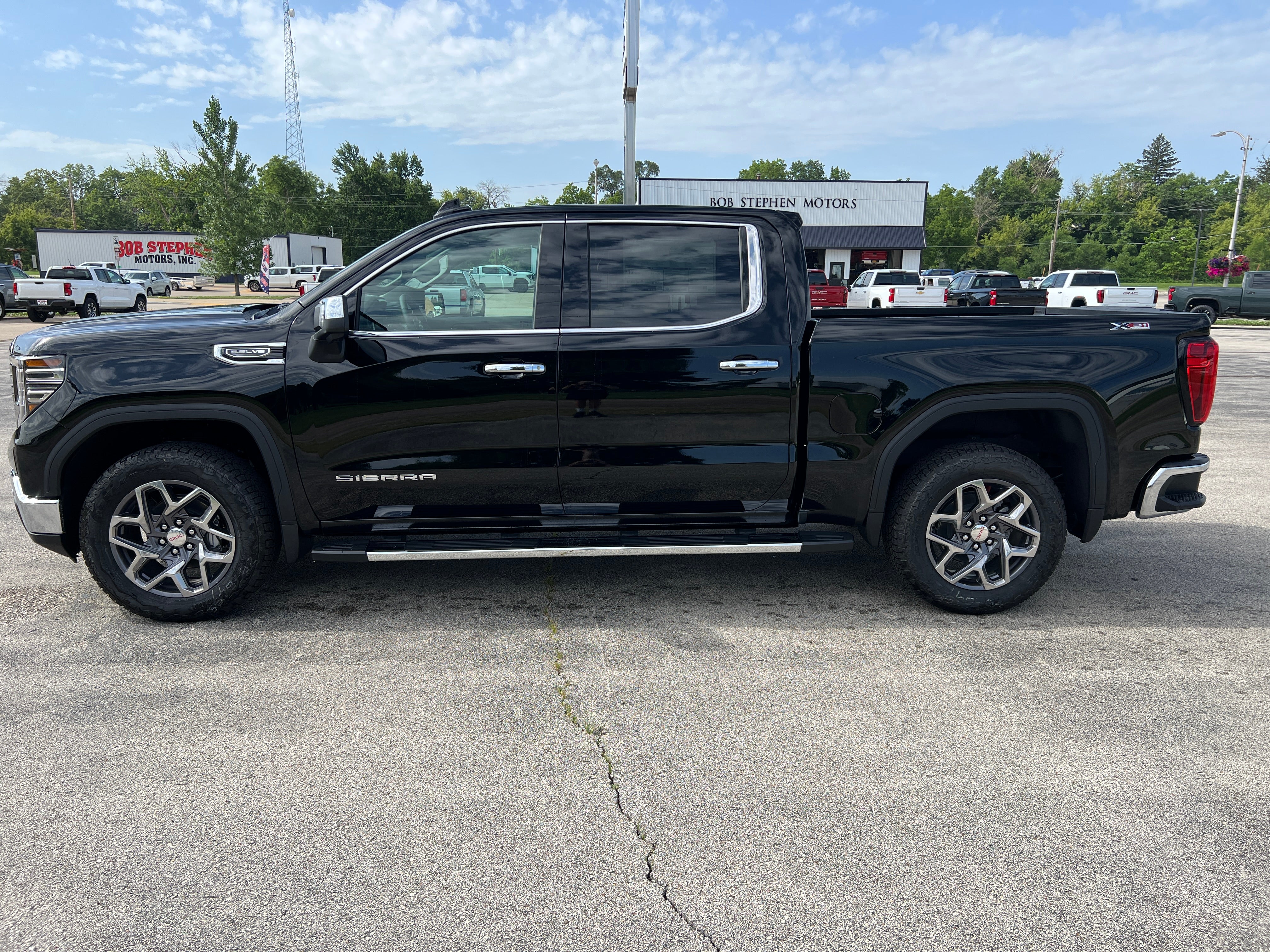 2026 GMC Sierra 1500 SLT in Onyx Black — front three-quarter view