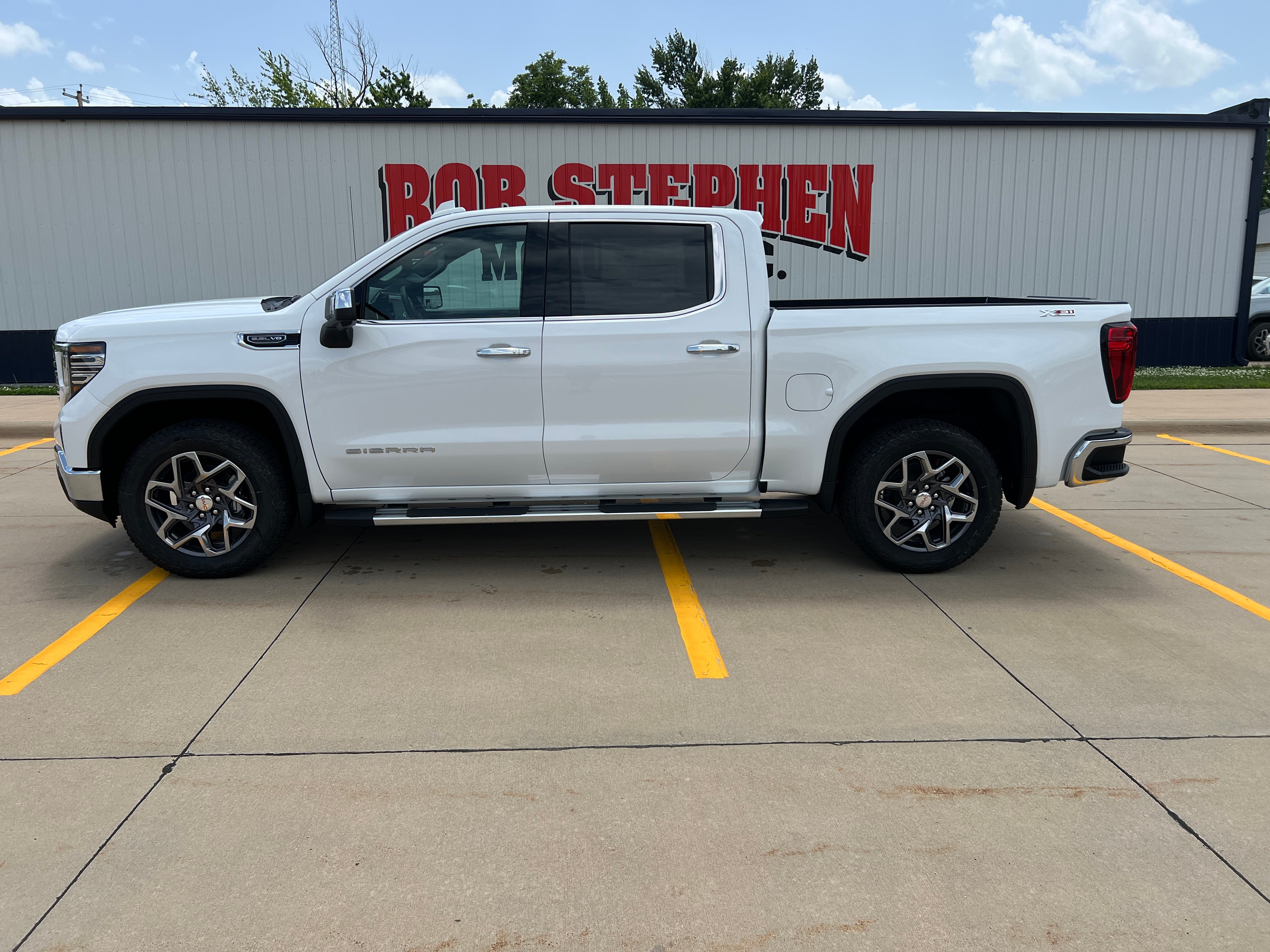 2026 GMC Sierra 1500 SLT in Summit White — front three-quarter view