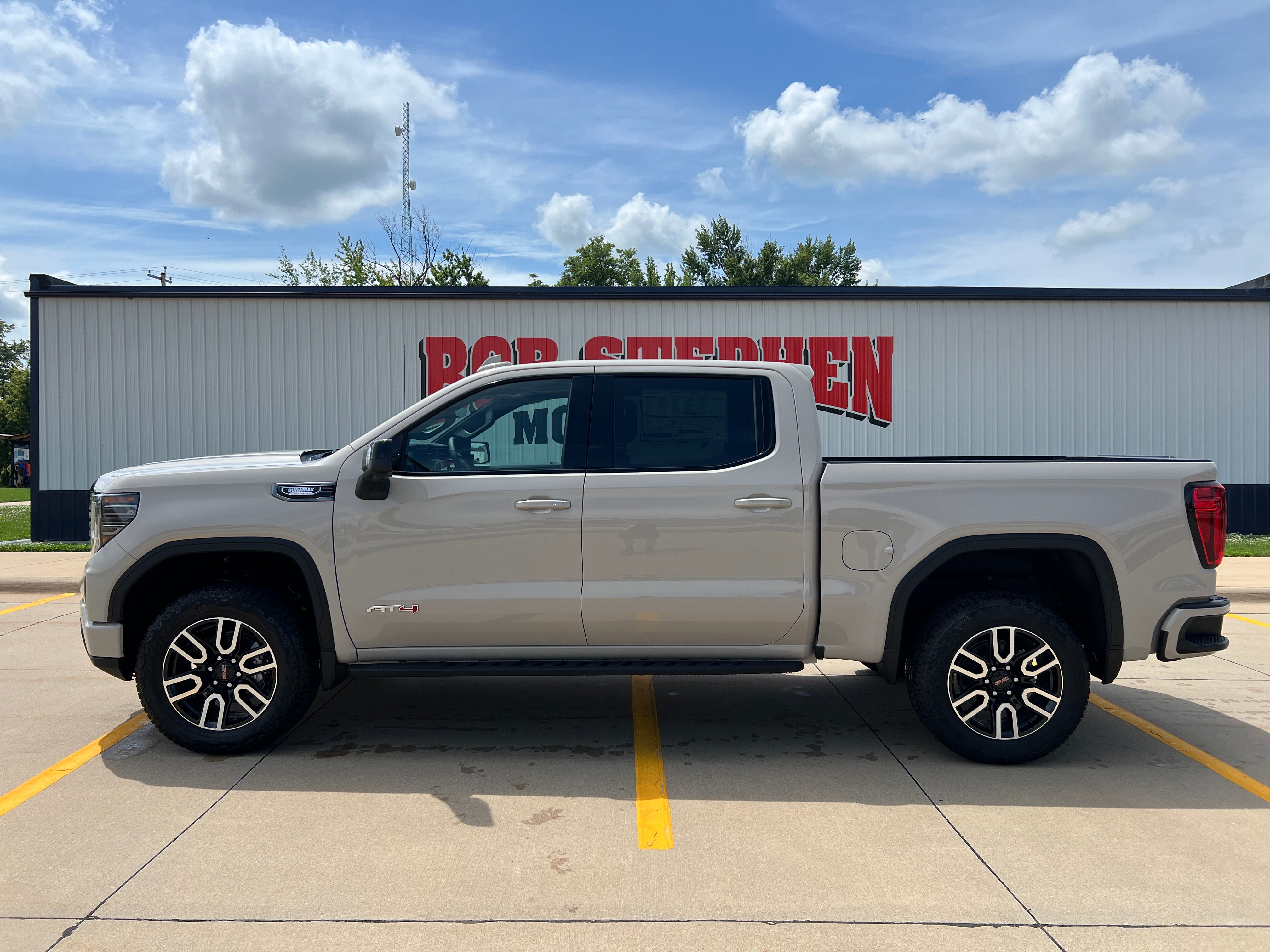 2026 GMC Sierra 1500 AT4 in Coastal Dune — front three-quarter view